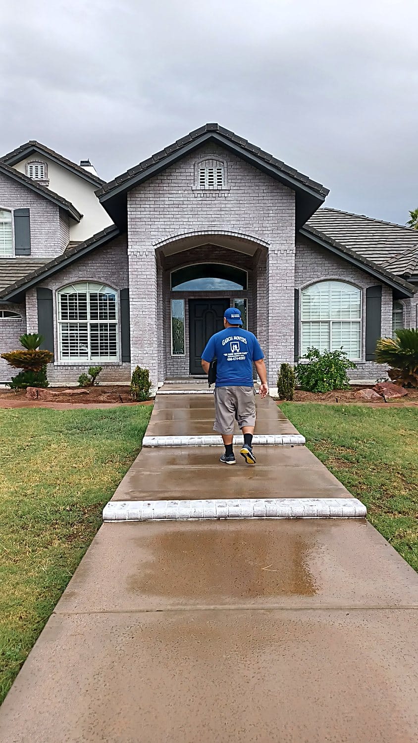 A Garcia Movers crew member in a branded shirt at a customer's home in the East Valley