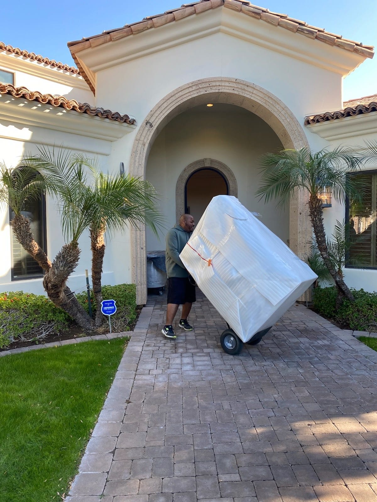 A large wrapped piece arriving at the customer's front door