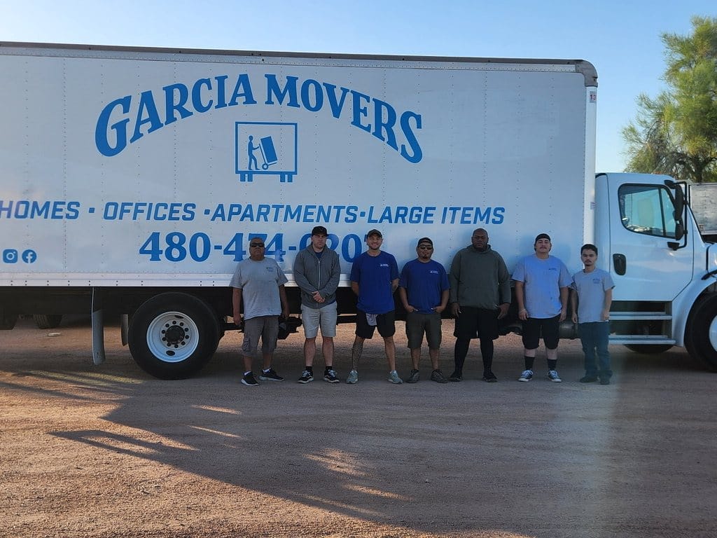 The Garcia Movers crew lined up in front of the company truck